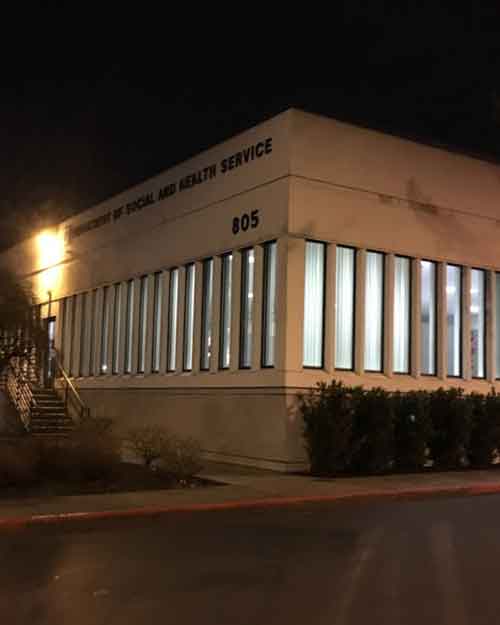 Exterior view of the Washington State Department of Children, Youth & Families (DCYF) building, responsible for overseeing daycare costs and childcare regulations in Washington.