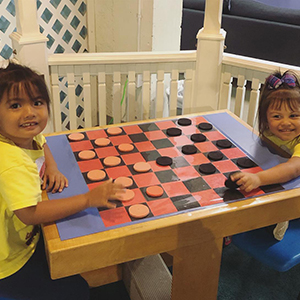 Love-A-Keiki-Learning-Center-kids-playing-board-game.jpg